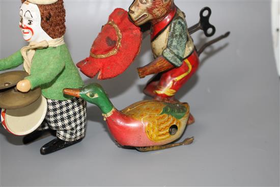 Three old tinplate clockwork toys and a tinplate cannon